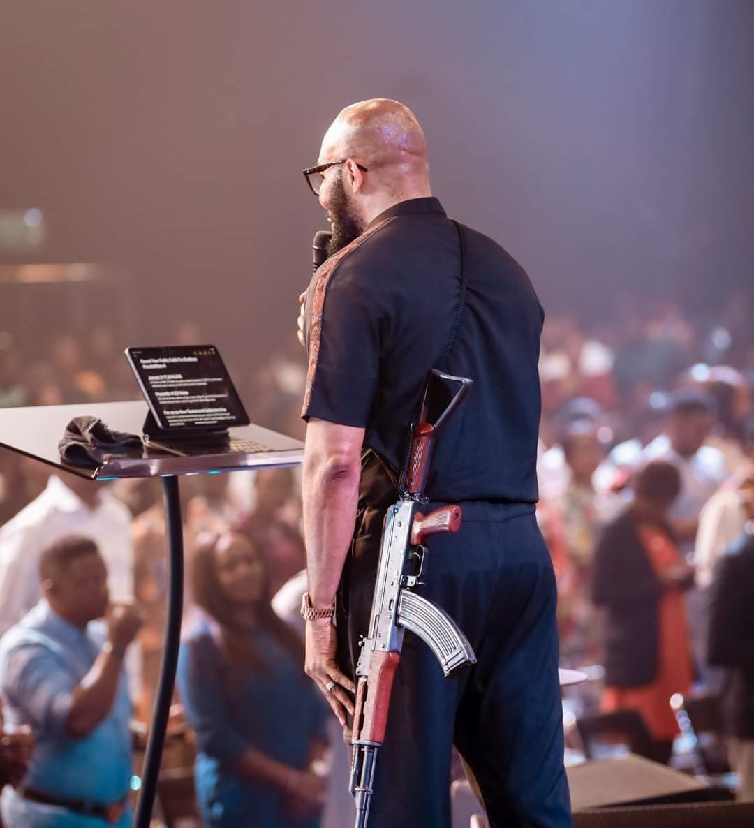 Tweeps react as Abuja pastor storms altar with AK-47